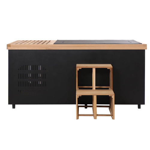 Black outdoor kitchen island with wooden countertop and stools on a white background